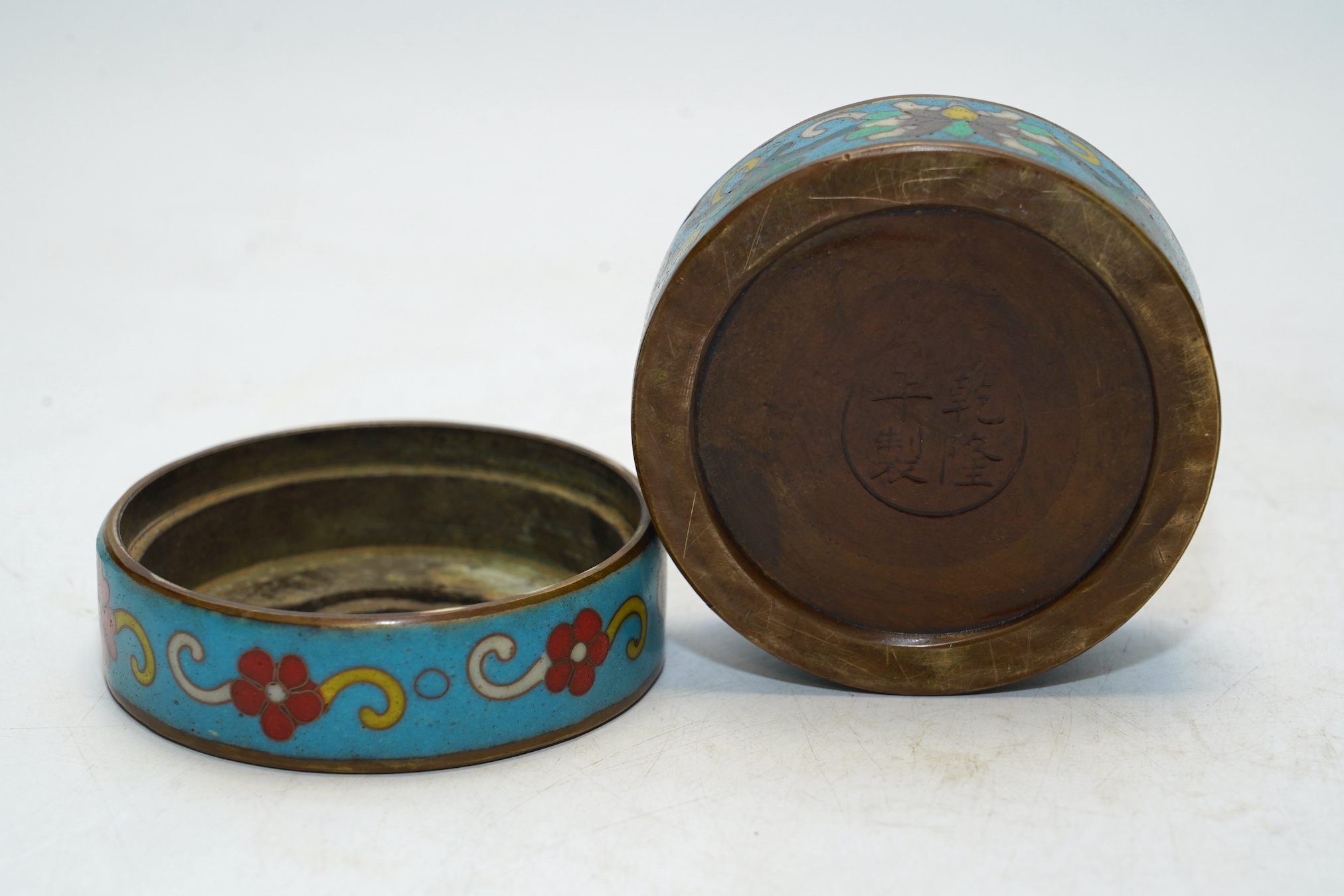 A heavy Chinese cloisonné incense box enamelled with flowers, apocryphal Qianlong mark 8cm in diameter. Condition - fair